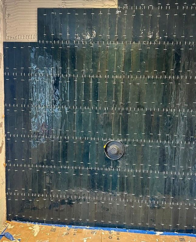 Tiling in progress — you pay for the substrate prep and tile alignment you can no longer see once the project is finished.